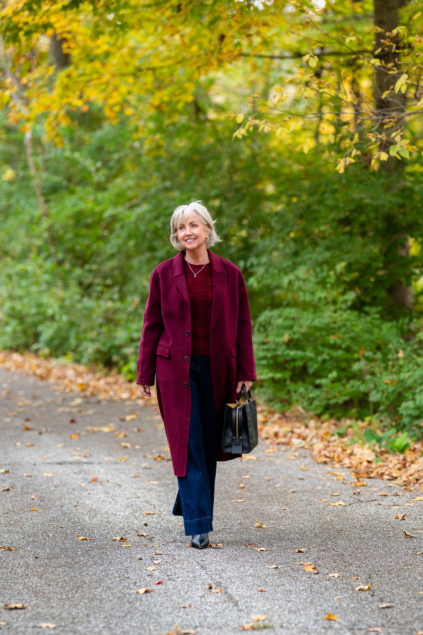 Woman wearing a burgundy cardigan outdoors in fall