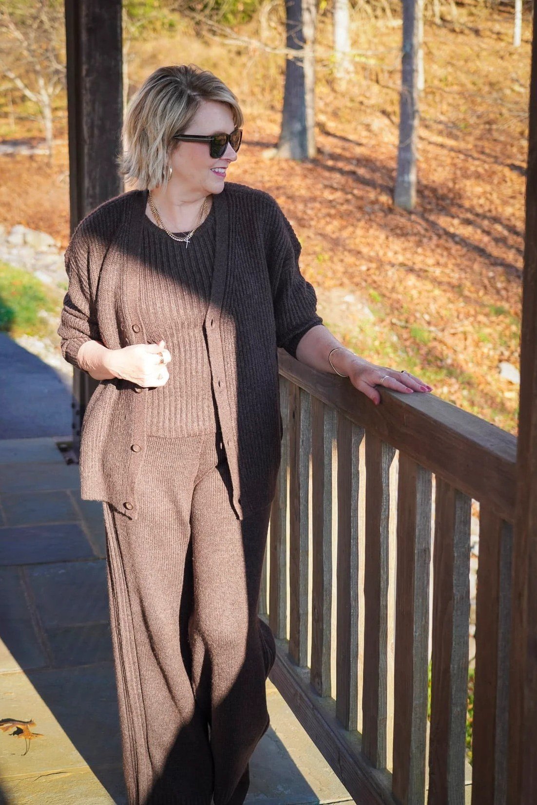 Woman in a brown sweater with wide taupe trousers