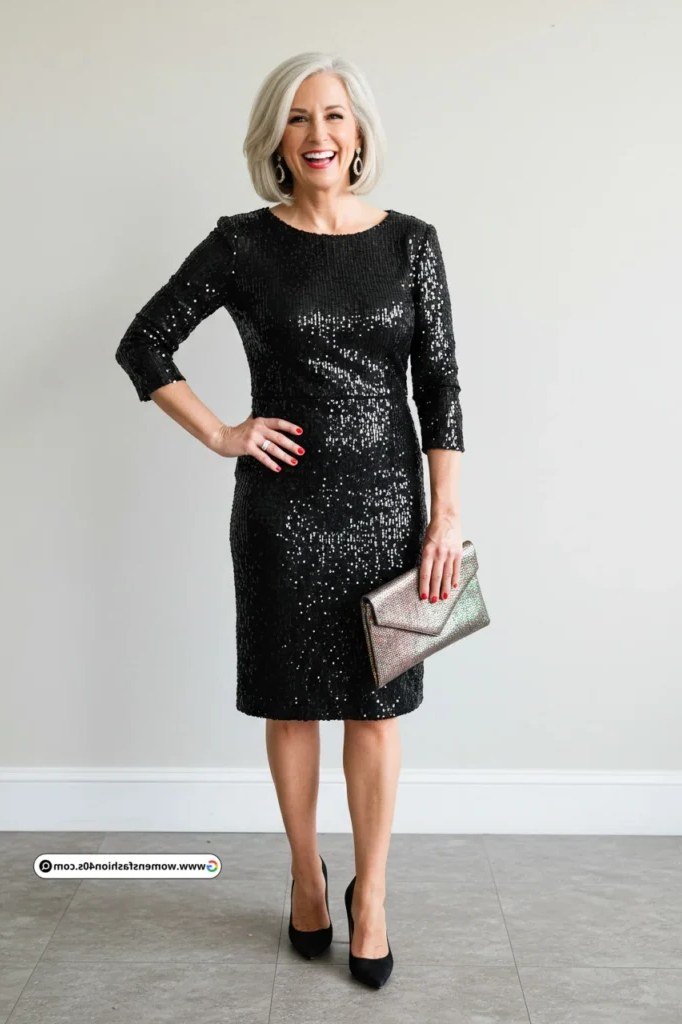Fall dinner outfit for women over 50: black sequin three-quarter-sleeve cocktail dress, silver clutch