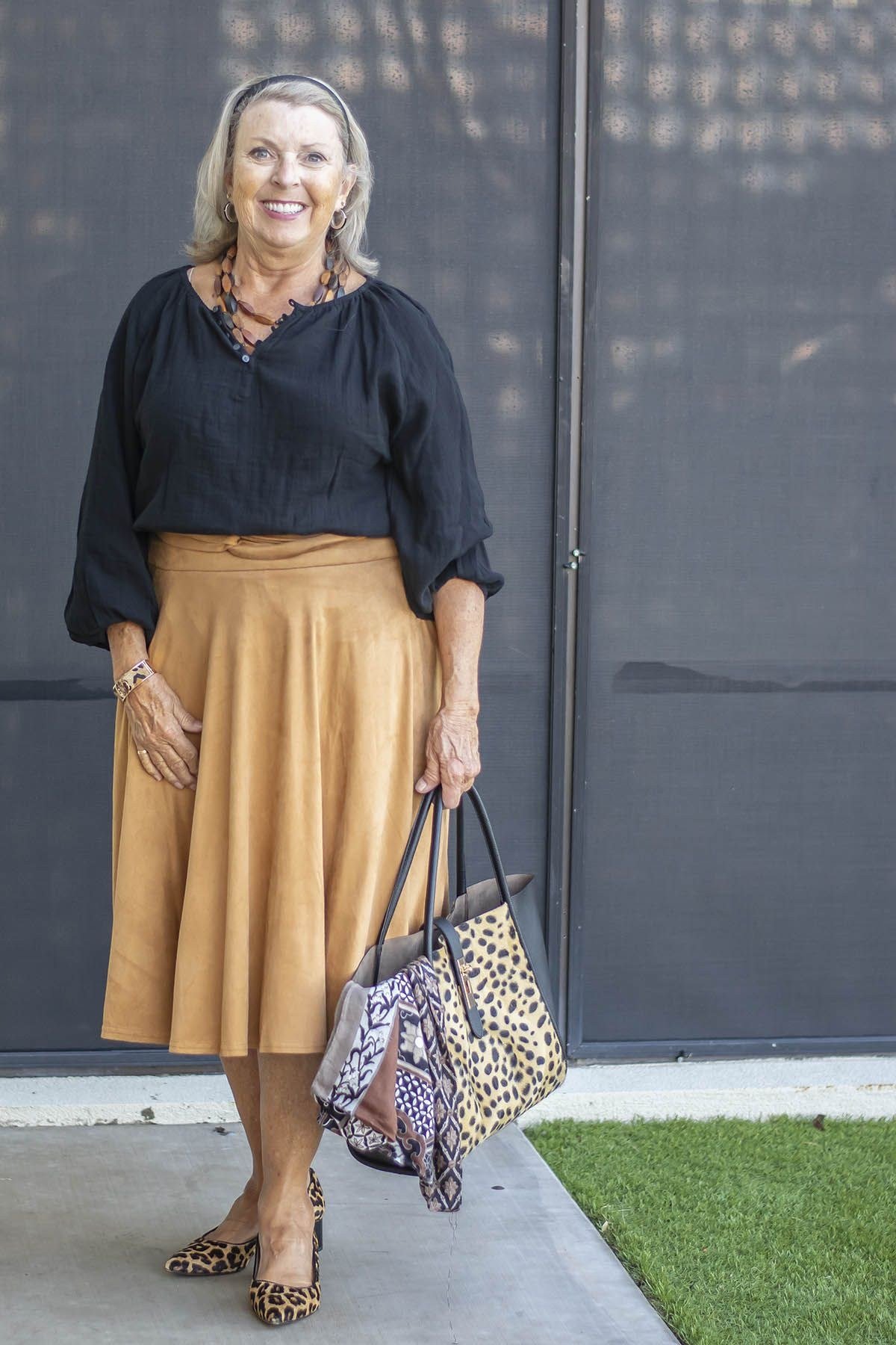 Fall dinner outfit for women over 50: navy blouse with camel satin midi skirt