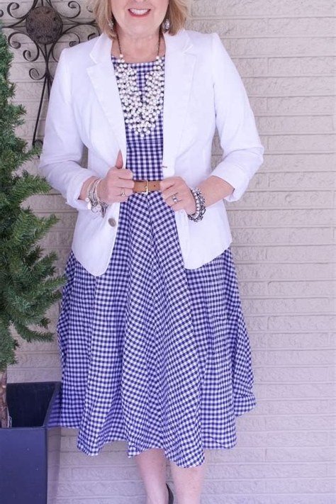 Fall dinner outfit for women over 50: white blazer over gingham midi dress, black heels