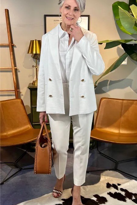 Fall dinner outfit for women over 50: white double-breasted blazer with white wide-leg trousers