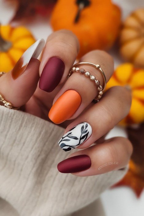 Burgundy, orange and white marble nails with mini pumpkins