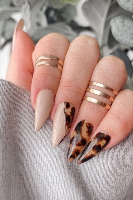Nude nails with tortoise accent nails
