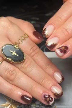Dark burgundy nails with gold rings