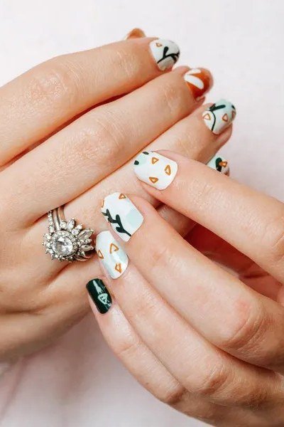 White nails with green and black fall art