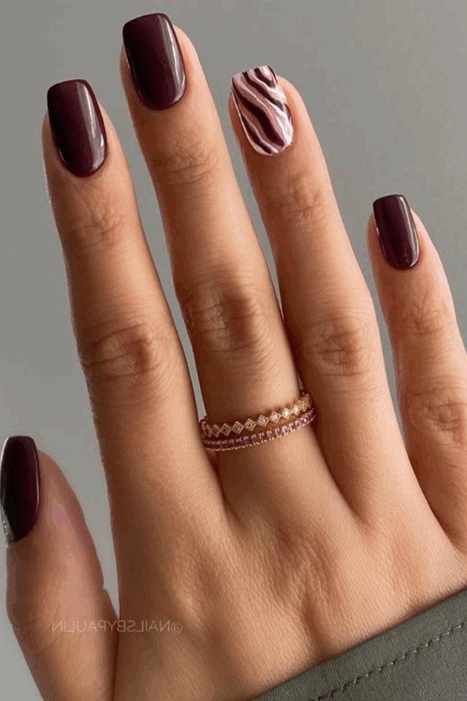 Plum nails with a zebra accent nail