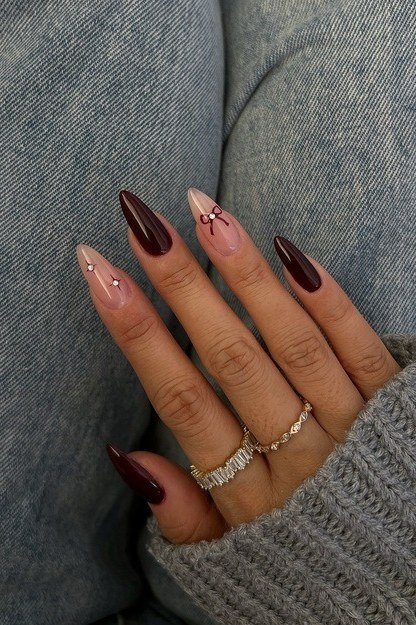 Burgundy and nude nails with a rhinestone accent