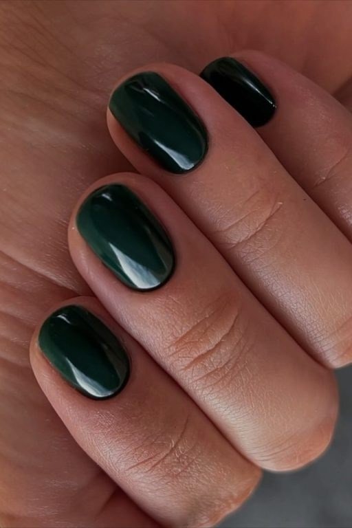 Deep emerald green short oval nails for women over 60