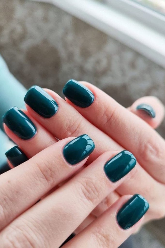 Deep teal nails with pumpkin decor for women over 60