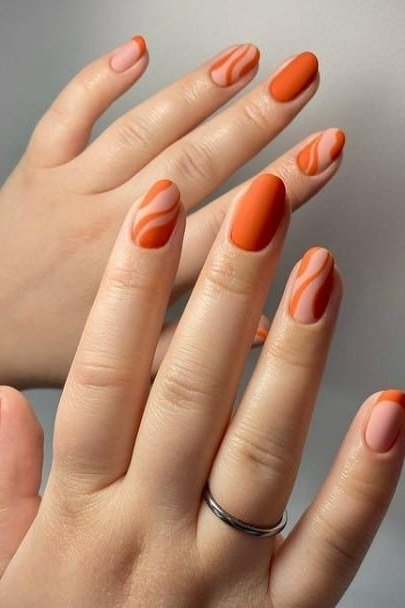 Burnt orange nails with swirl art for women over 60