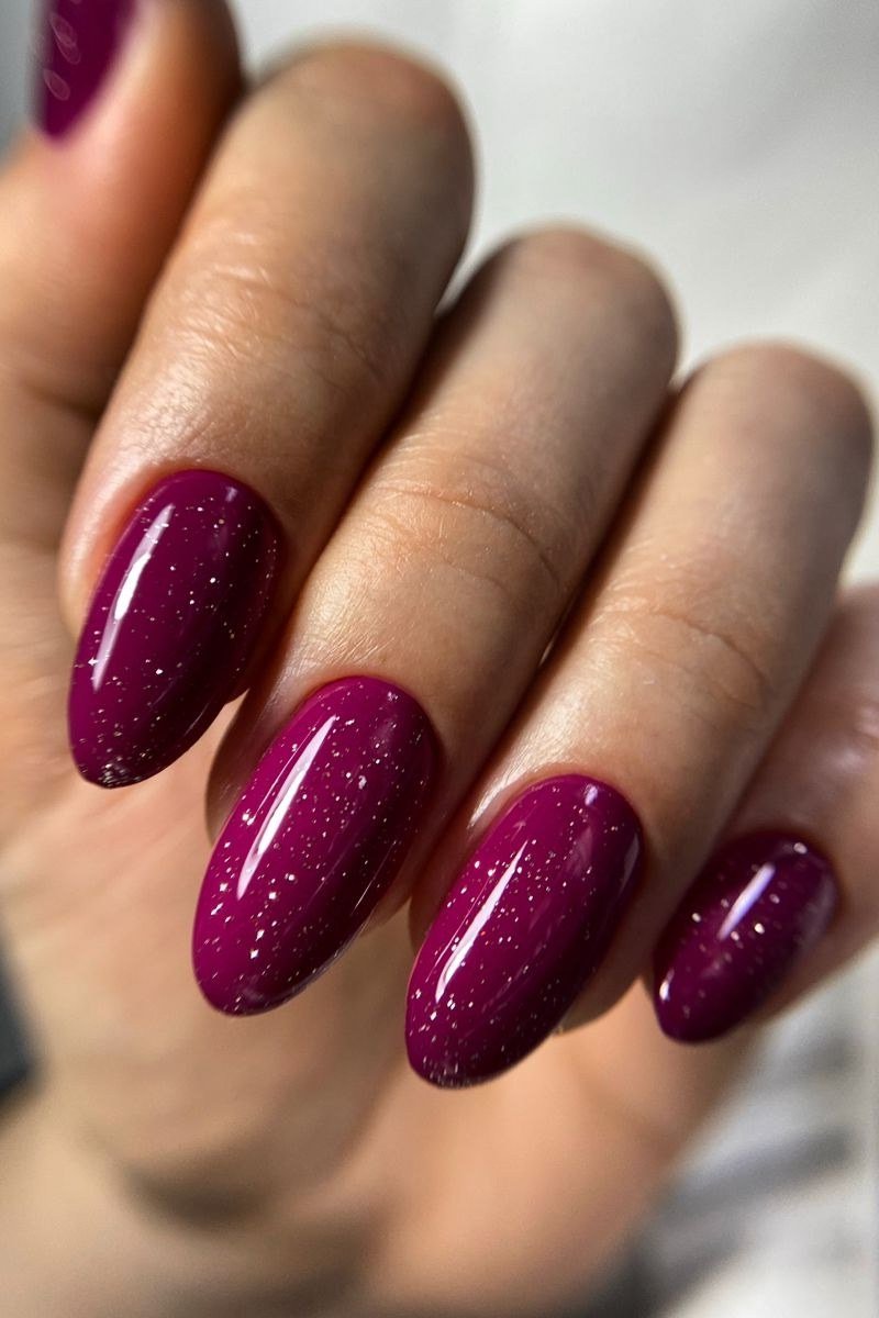 Magenta shimmer almond nails for women over 60