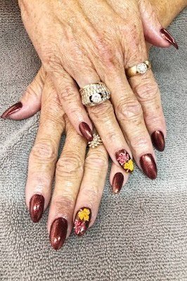 Burgundy nails with tiny gold and red floral accent nail art