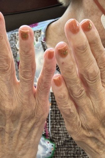 Sheer nude manicure on elegant elderly hands