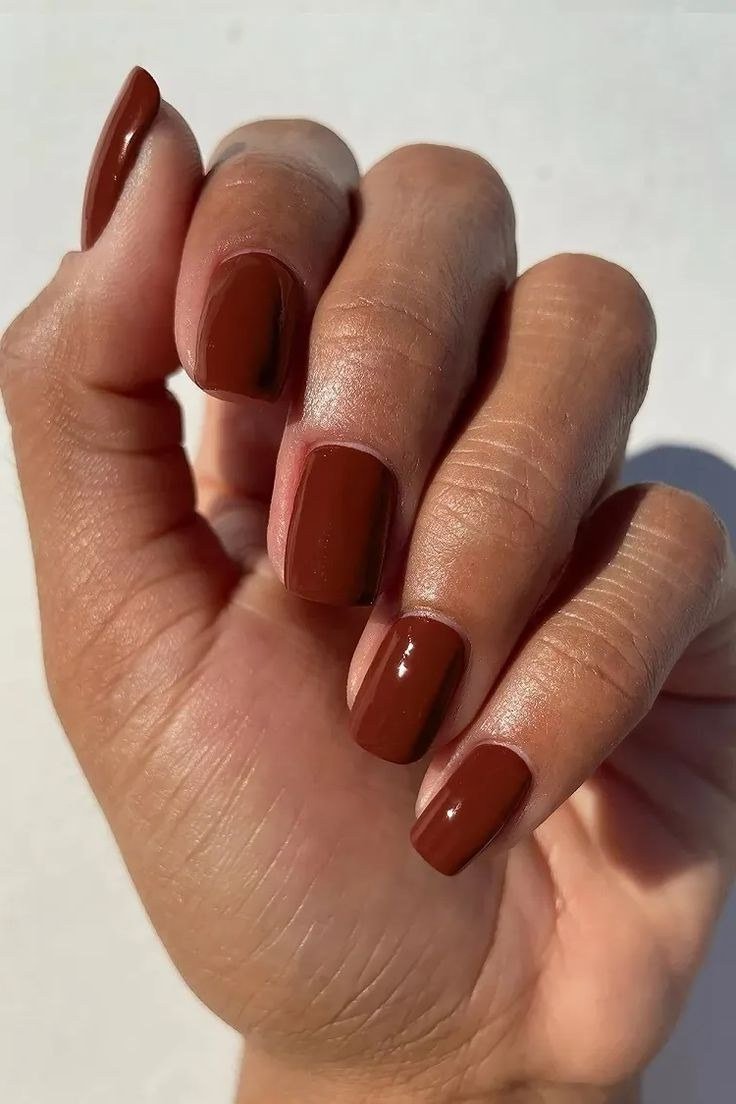 Terracotta orange-brown nails on deep skin