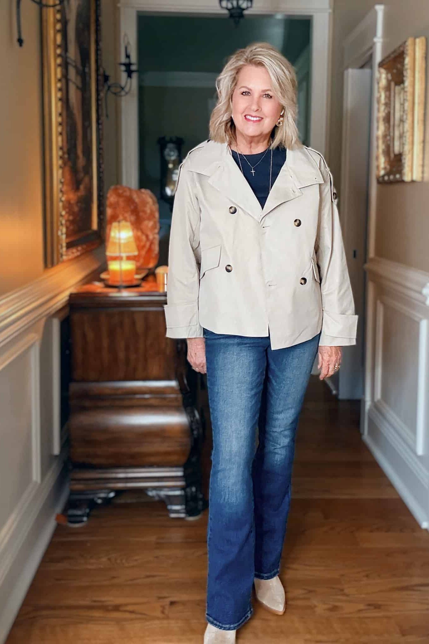 Cream short trench coat with navy top and jeans for women over 50