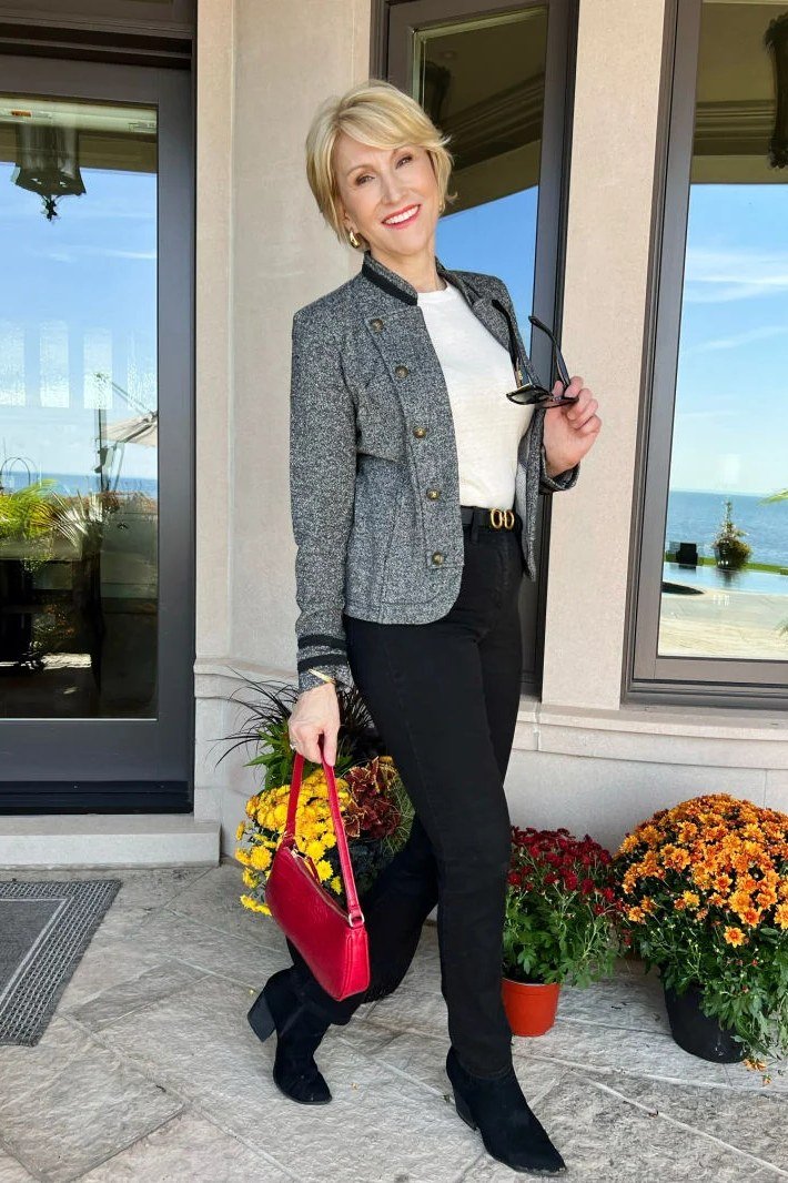 Gray tweed jacket with white top black pants and red bag