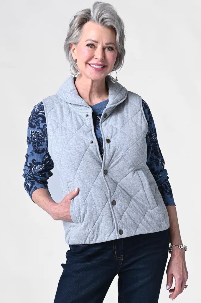 Light blue quilted vest over patterned top and jeans