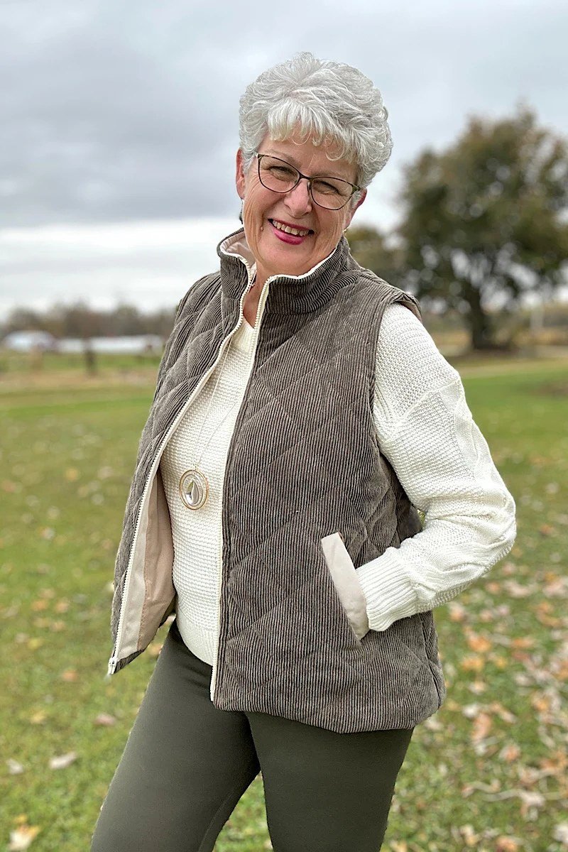 Brown quilted vest with white sweater and olive pants fall