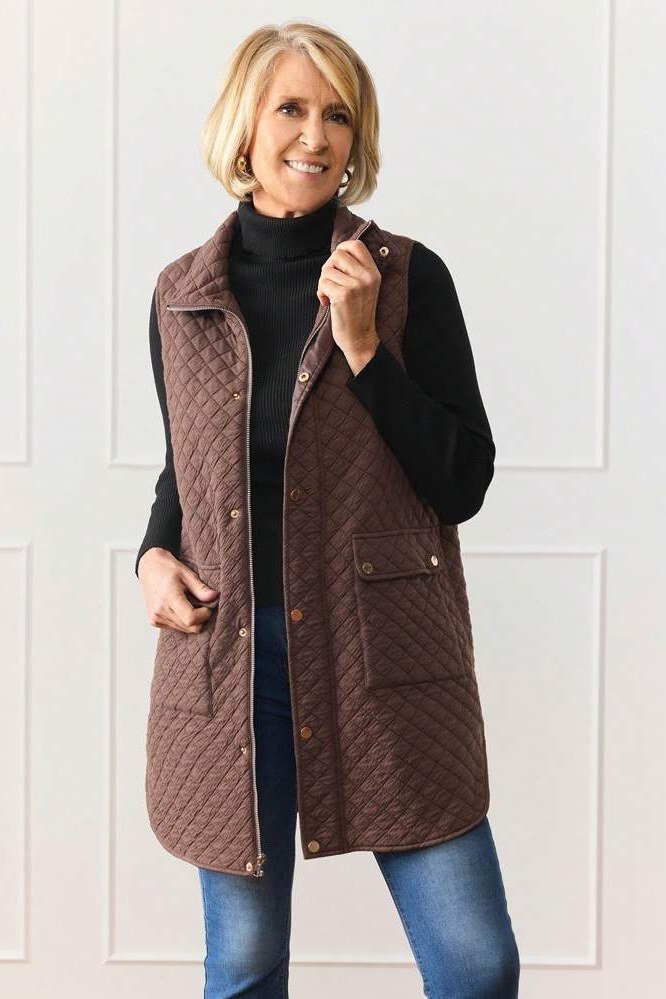 Long brown quilted vest with black turtleneck and jeans