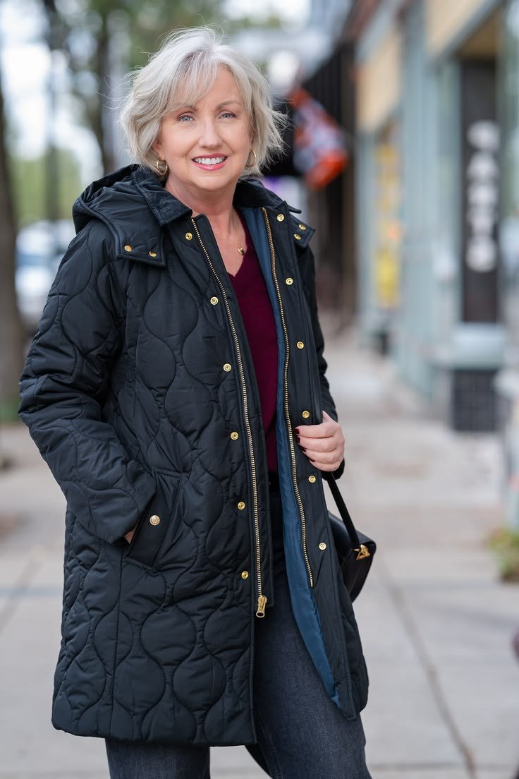 Black quilted long coat with burgundy top and jeans