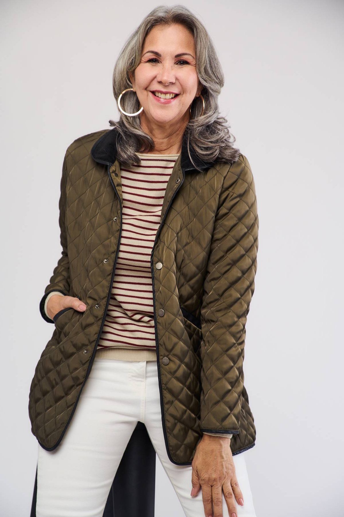 Olive quilted jacket with striped top and white jeans
