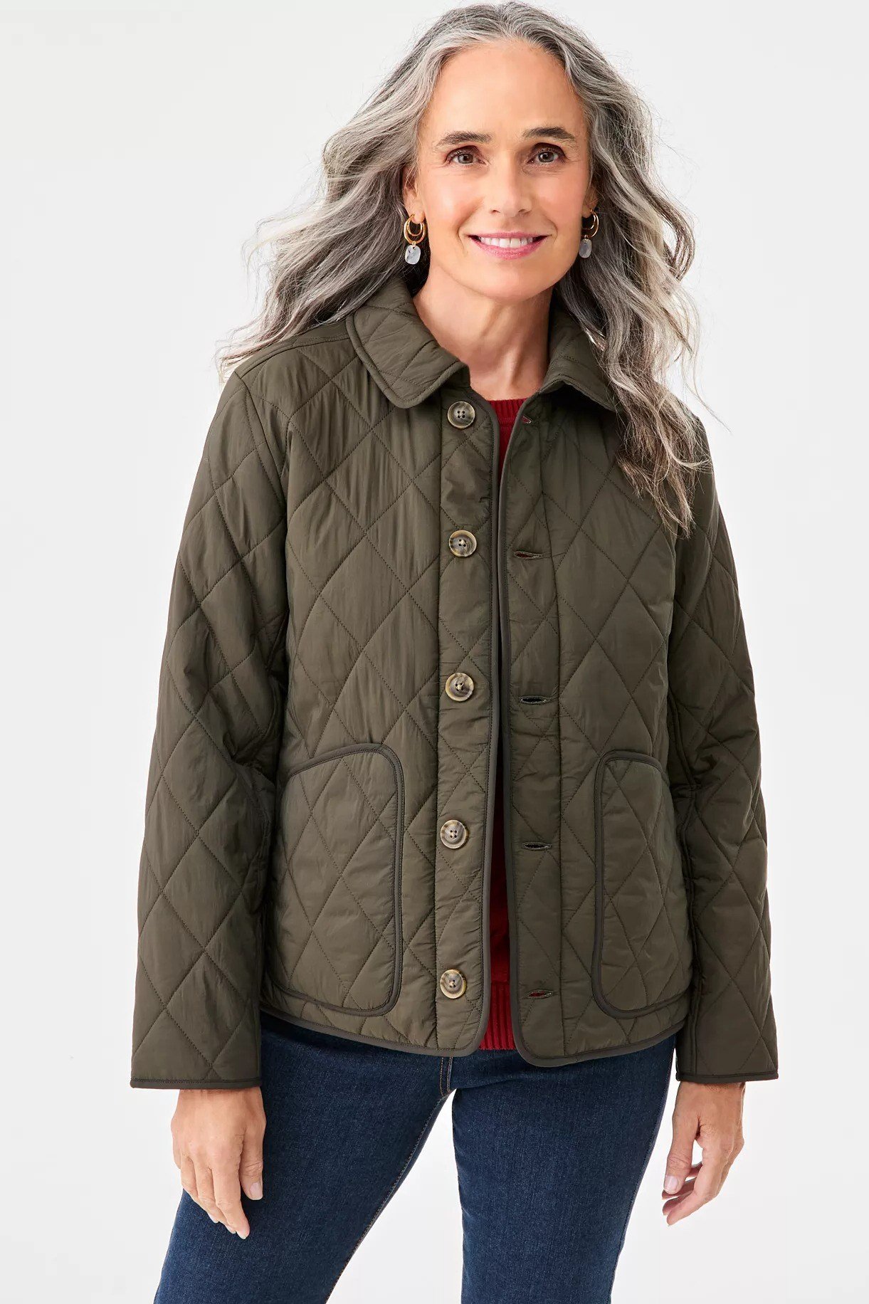 Olive quilted field jacket with red top and jeans