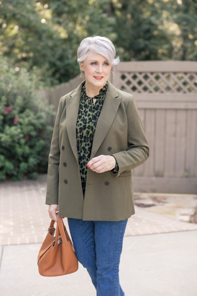 olive blazer with patterned blouse and blue jeans, fall work outfit for women over 50