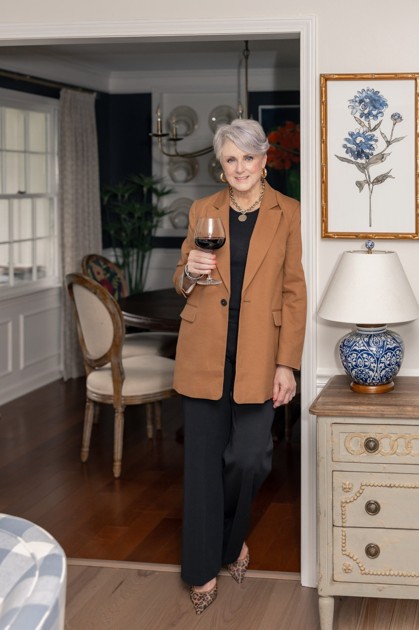 rust blazer with black top and black trousers, fall work outfit for women over 50