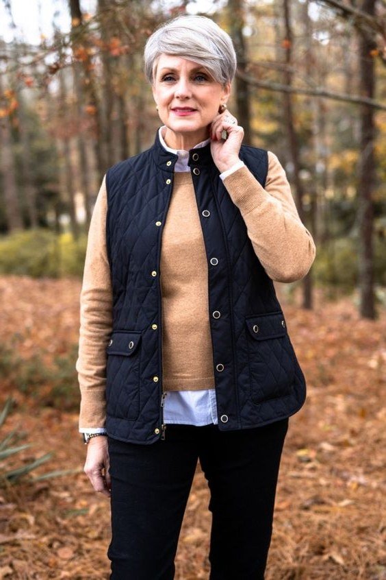 navy quilted vest with camel sweater and black trousers, fall work outfit for women over 50