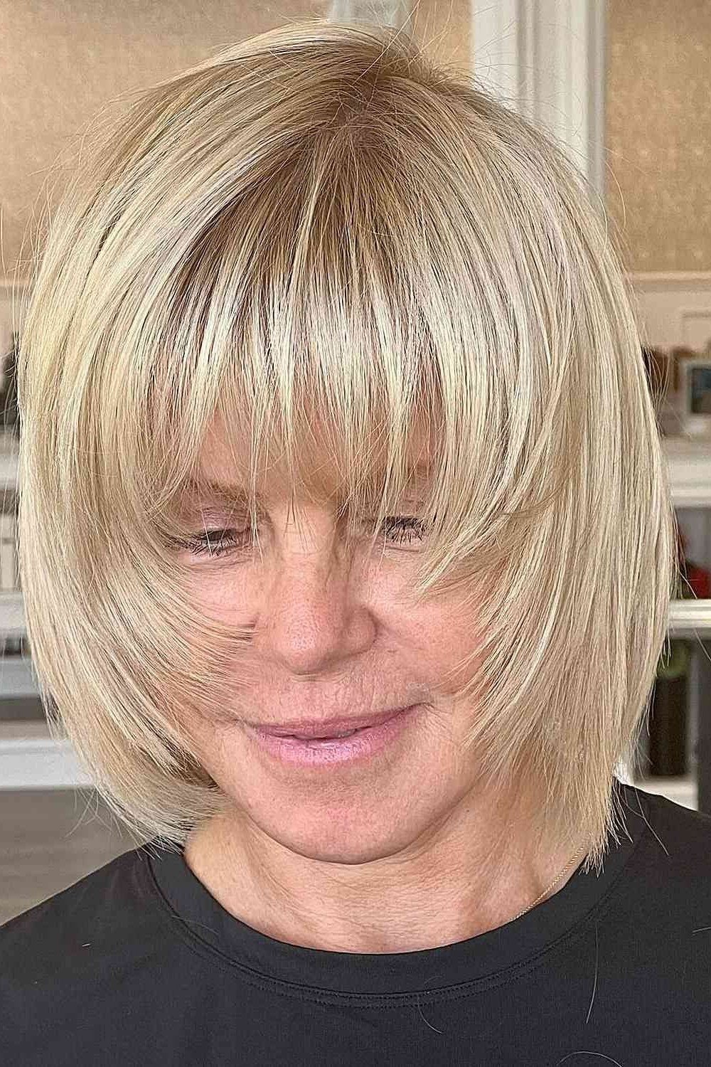 Blonde Feathered Bob with Full Bangs on an older woman - elegant feathered bob hairstyle idea