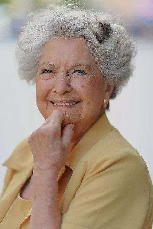 Grey Curly Feathered Bob on an older woman - elegant feathered bob hairstyle idea