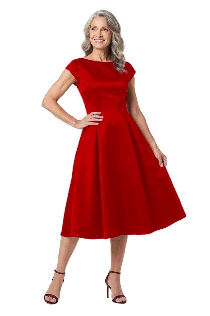 Fit-and-flare dress for women over 60: older woman with grey hair wearing a red cap-sleeve fit-and-flare midi dress, hands on hips
