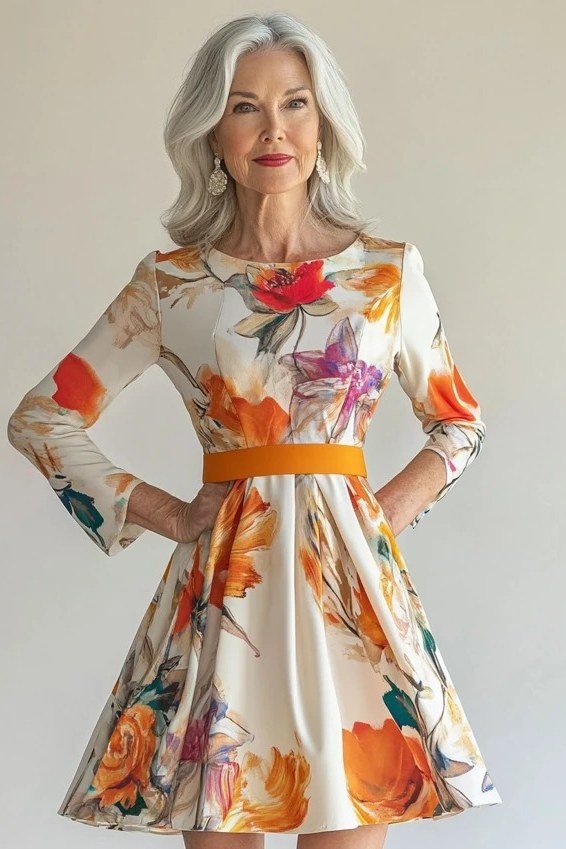 White floral fit-and-flare dress with orange belt for mature women, grey hair