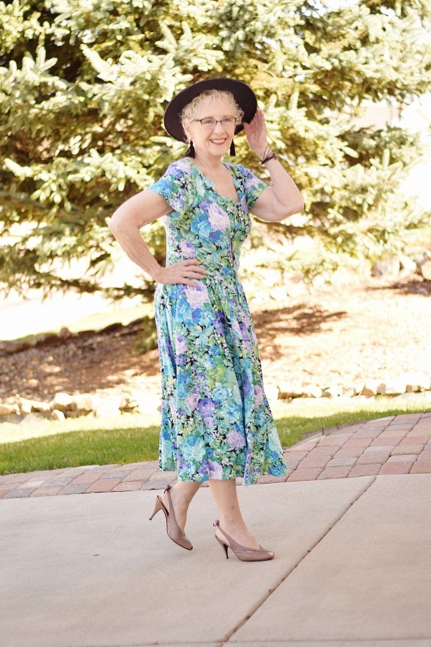 Green floral fit-and-flare midi dress for women over 50 on park path