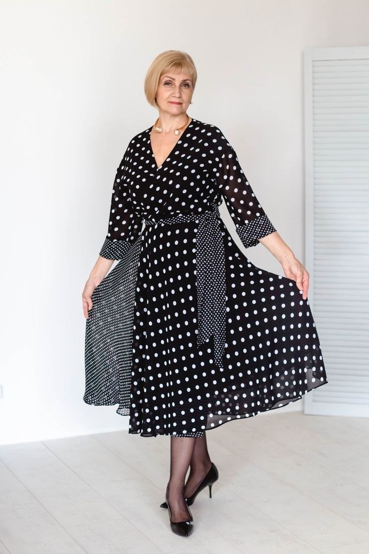 Black polka-dot wrap fit-and-flare maxi dress with flowing sleeves for blonde older woman