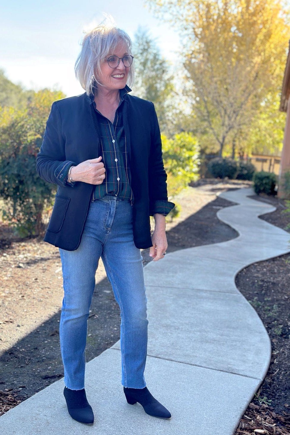 A navy blazer over a dark chambray shirt with light-wash jeans is smart and polished. Navy ankle boots tie the palette together. Sunglasses add confidence. Wonderful for lunch dates, travel, or smart casual offices.