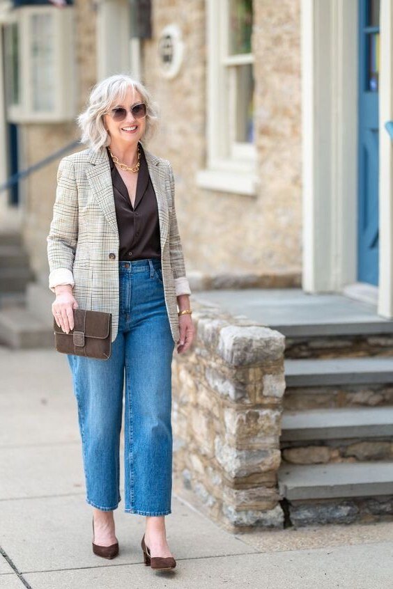 A beige blazer over a dark top with light-wash straight jeans is soft and sophisticated. Brown heels warm the neutral palette. The look feels fresh and modern. Beautiful for brunch or a daytime event.