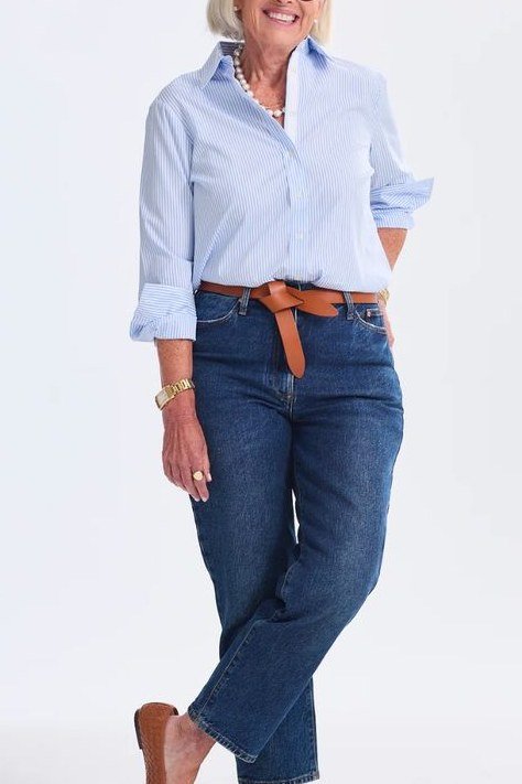 A light blue button shirt with dark jeans and a tan belt is crisp and classic. The clean lines really show. The tan belt defines the waist beautifully. A timeless look for any casual occasion.