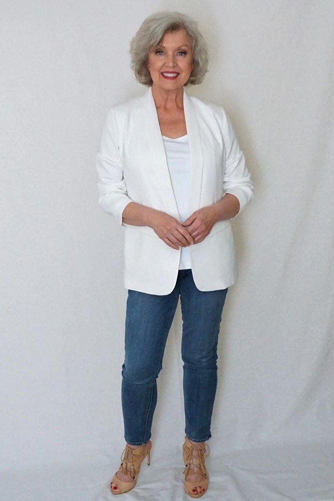 A white blazer over a white top with medium jeans and tan ankle boots is fresh monochrome dressing. The look is clean and modern. Tan boots ground the pale palette. Perfect for daytime events or mild fall days.