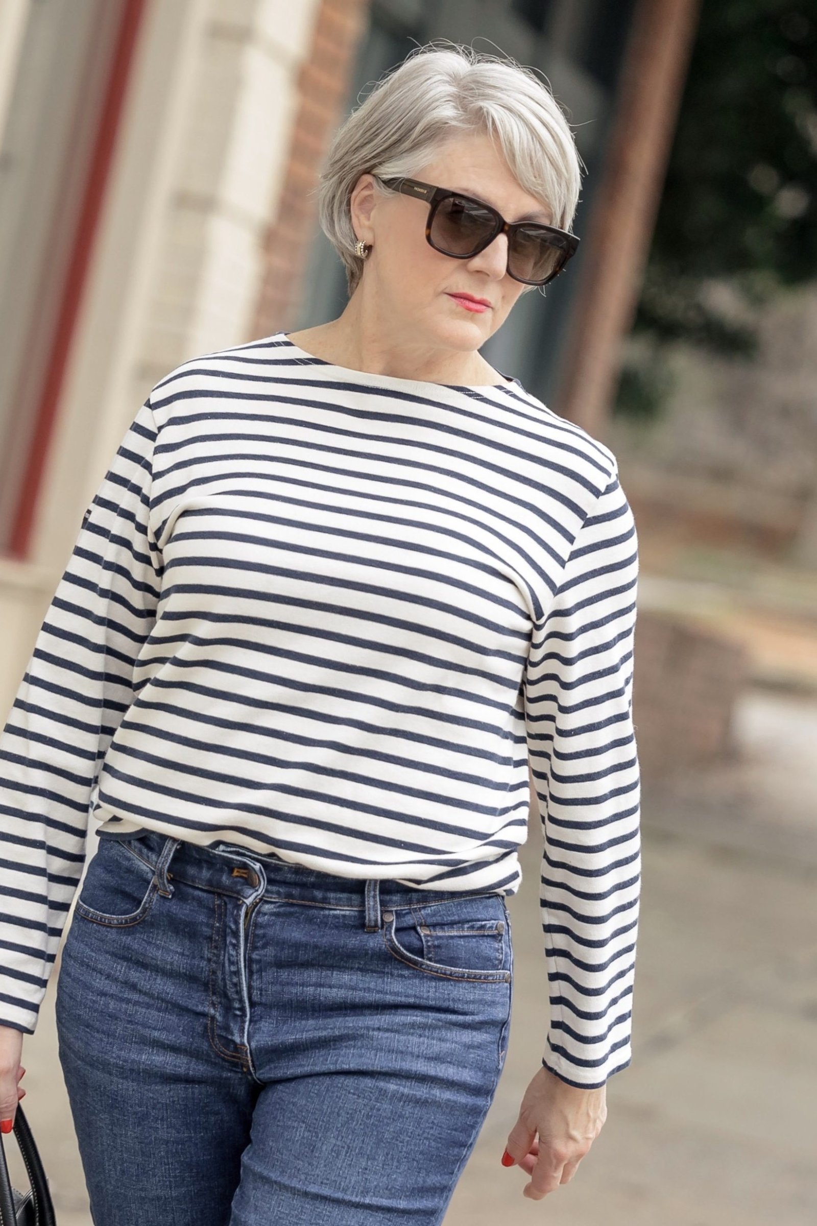 A striped long-sleeve top with medium jeans is the ultimate easy outfit. Sunglasses add a cool finish. Gray hair looks chic with classic stripes. Perfect for errands, travel, or any casual day.
