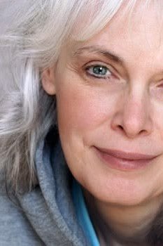 Wavy silver lob, hoodie top, smiling grey hairstyle for women over 50