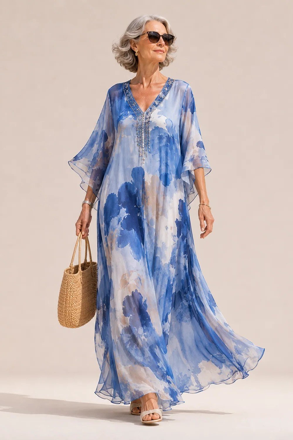 Blue and white watercolor maxi dress with a straw bag, breezy summer style for older women