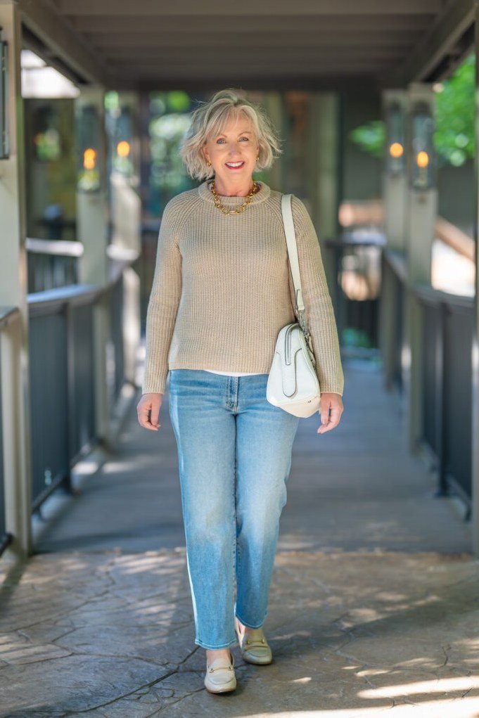 Tan sweater with light wash jeans on a fall day, casual outfit for mature women