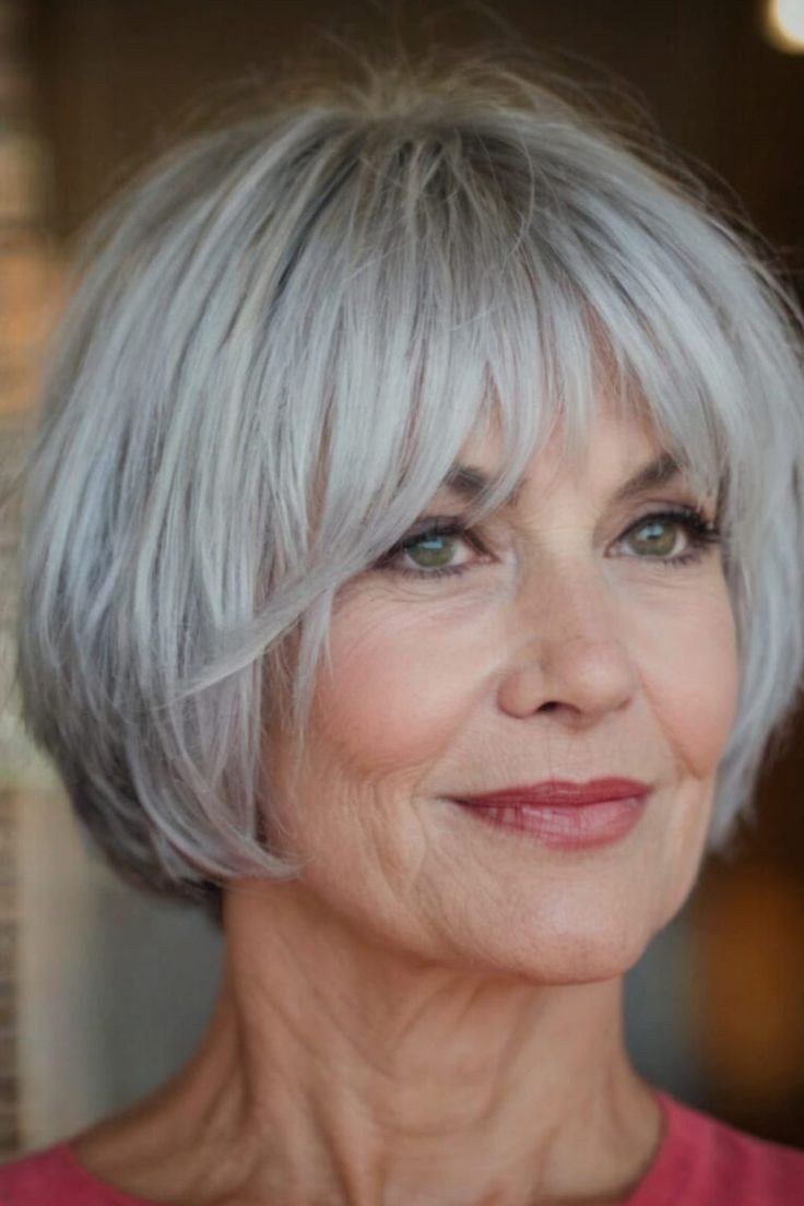 Silver bob with bangs, front view, smiling grey hairstyle for women over 50