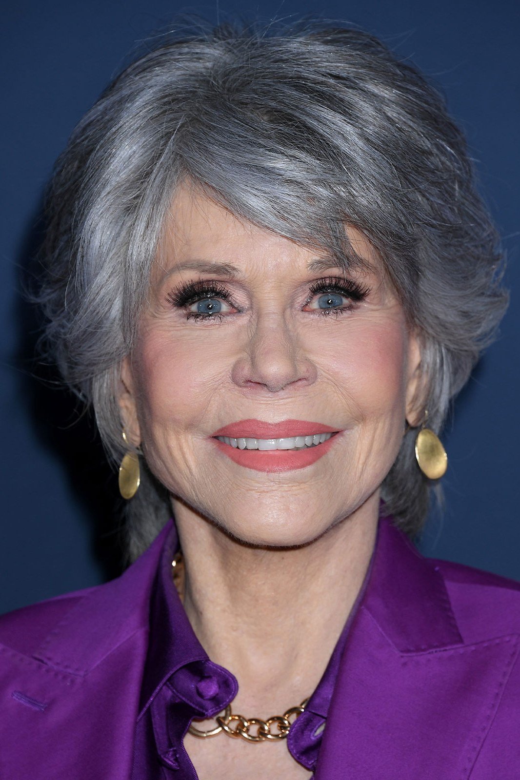 Silver layered shoulder hair, purple blazer grey hairstyle for women over 50