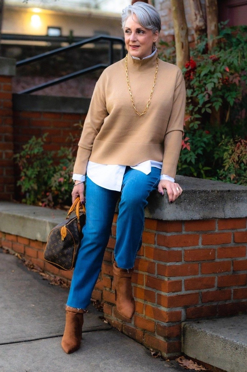 Camel turtleneck sweater with blue trousers, elegant fall look for older women