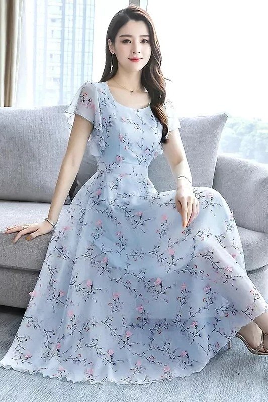 Pale blue floral chiffon maxi dress, seated elegant summer look for women over 60
