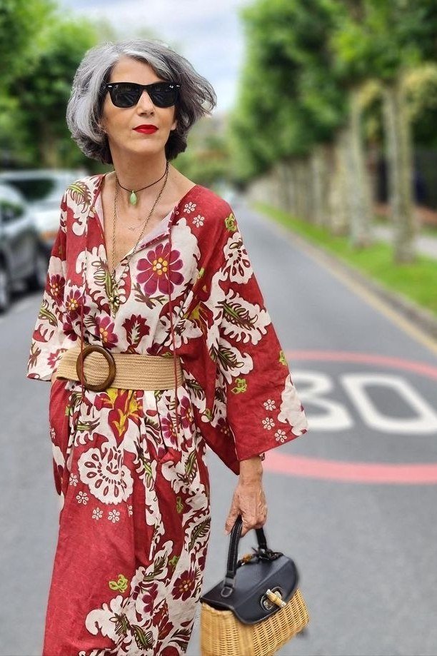 Red floral wrap maxi dress with a tan belt and sunglasses, striking summer street style for older women