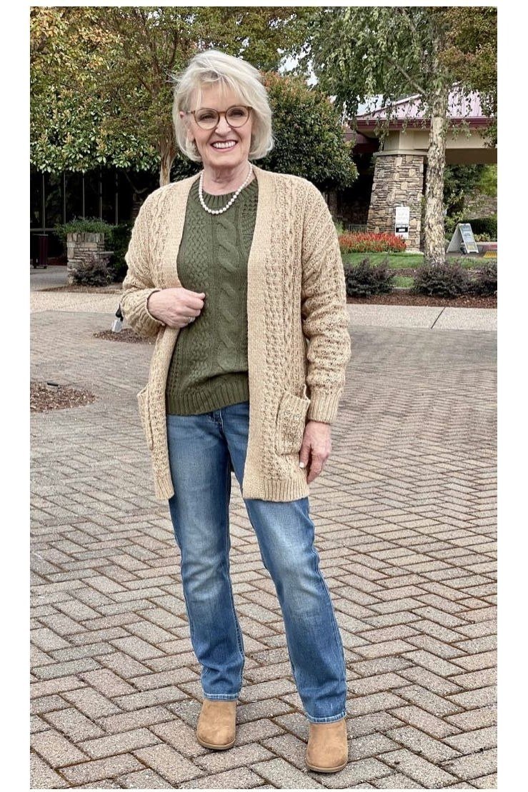 Tan cardigan with olive top and blue jeans, earthy fall outfit for mature women